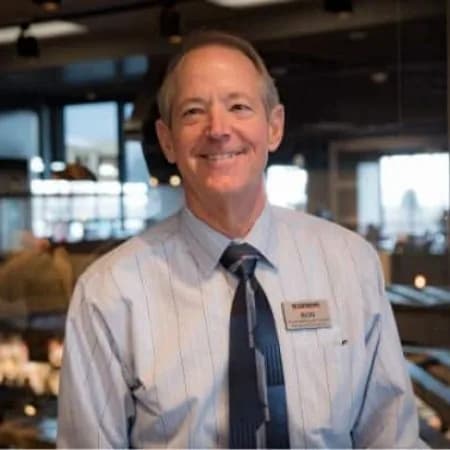 A Harmons associate in a shirt and tie