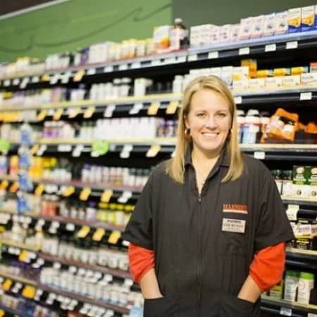 A smiling Harmons associate in the store