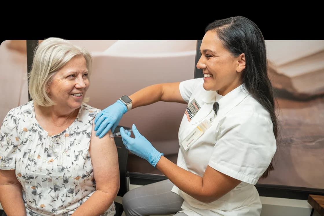 Harmons pharmacist giving a customer a vaccine