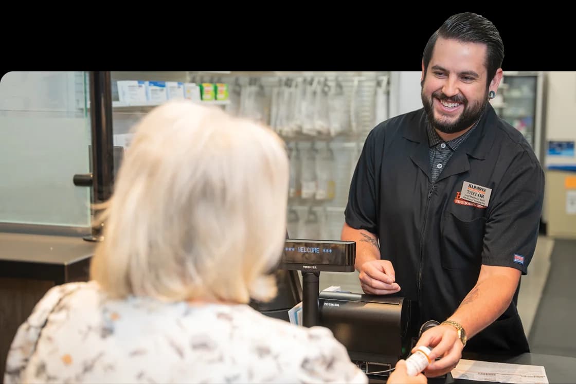 Harmons pharmacy team member helping a customer at the pharmacy counter